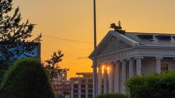 Sunlit neoclassical building crowned by a horseman statue, evoking Twilights Magic Hour and evocative of National Architecture Day photo