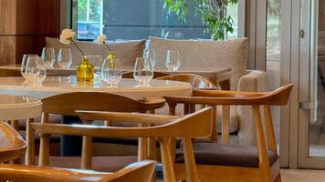 Elegant minimalist dining setting with wooden chairs, echoing Nordic simplicity, perfect for Hygge gatherings and Slow Food Movement celebrations photo