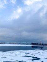 Frozen lake with fragmented ice under a brooding sky, evoking Winter Solstice introspection and serene Nordic mystery photo