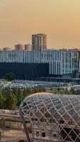 Futuristic urban skyline at sunset, architectural harmony with geometric patterns, celebrates World Architecture Day and Solar Appreciation Month photo
