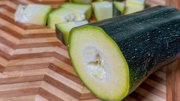 Sliced zucchini on a geometric wooden board, celebrating ancient Harvest Moon festivals and quirky garden to table cuisine adventures photo