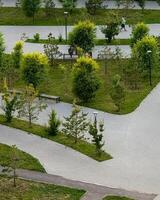 Paved labyrinth amid whispering trees, an Asian male jogger embraces serene urban harmony, perfect for Silent Walk Day photo