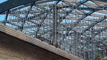 Steel beams interlace like metallic spider webs, capturing urban growth during Skyscraper Day under a skyward promise architecture photo