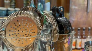 Gleaming cocktail strainers and shakers exude winter solstice merriment, hinting at hidden speakeasy whispers and Wren Day revelry photo