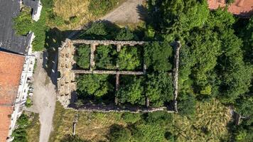 Half-ruined ancient castle German building in Poland, Mietkow, Borzygnev. Drone view. photo