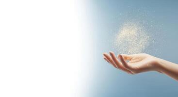 Sand is falling from a womans hand in a gentle stream photo