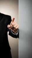 A businessman in a suit is pointing his finger to the side photo