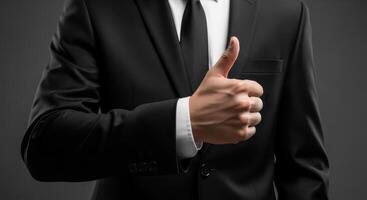 A businessman gives a thumbs up gesture for success and approval photo