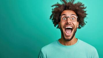 Young man with curly hair showing excitement against a vibrant green background during a playful moment, showcasing joy and happiness photo
