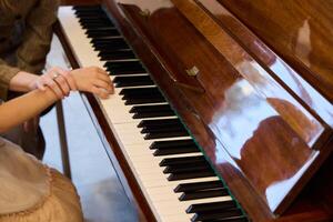 Stunningly Beautiful Hands Skillfully Playing the Piano with an Elegant Reflection photo