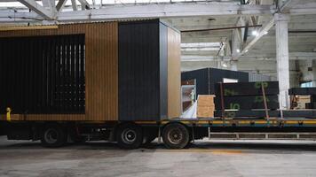 Prefabricated tiny house leaving factory loaded on flatbed truck video