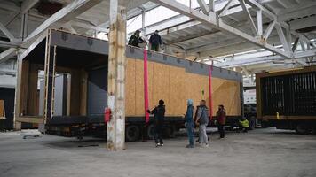 Workers moving prefabricated modular house in factory. Ternopil, Ukraine - 1 February 2025 video