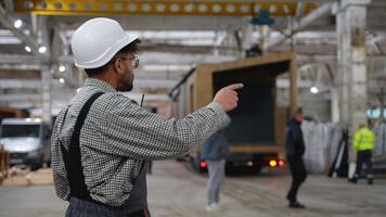 Construction site manager guiding prefabricated house module transportation video