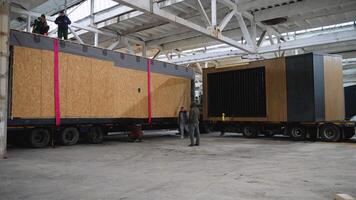 Engineers unloading prefabricated modular house in warehouse. Ternopil, Ukraine - 1 February 2025 video