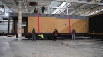Engineers inspecting modular house loaded on truck in factory. Ternopil, Ukraine - 1 February 2025 video