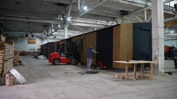 Workers moving prefabricated modular house in factory. Ternopil, Ukraine - 1 February 2025 video