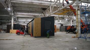 Factory workers moving prefabricated tiny house module. Ternopil, Ukraine - 1 February 2025 video
