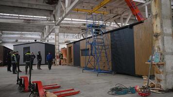 Engineers observing lifting of prefabricated modular house in factory video