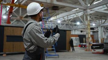 Supervisor communicating with walkie talkie in factory video