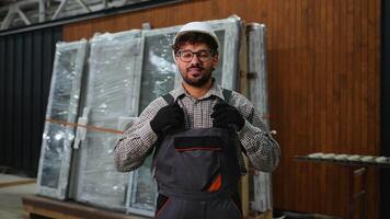 Smiling construction worker gesturing with hands in factory video