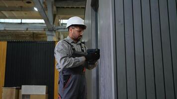 Construction worker using cordless screwdriver on wall panel video