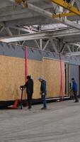 Factory workers moving prefabricated building module using pallet jack. Ternopil, Ukraine - 1 February 2025 video