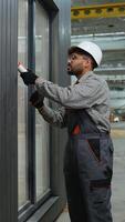 Construction worker applying sealant to window frame video