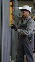 Construction worker checking verticality with spirit level video