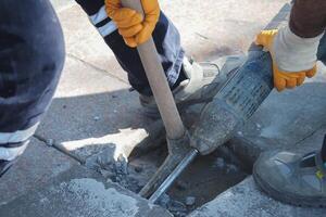Construction workers repair concrete surface with tools photo