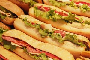 Freshly made subs displayed at a deli counter for lunch photo