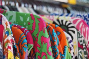 Colorful fabric patterns displayed at a market stall photo