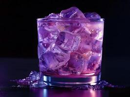 cold purple beverage in short glass with melting ice cubes on black surface photo