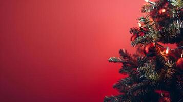 Decorated christmas tree branch with lights on vibrant red backdrop photo