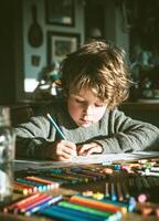 Young boy creating colorful artwork at a wooden table in a cozy home during afternoon light photo