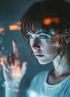 Young woman interacting with virtual interface displaying digital data in a futuristic environment photo