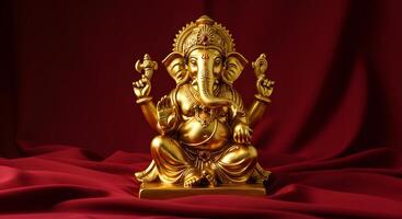 Golden Ganesha Sculpture on Red Fabric photo