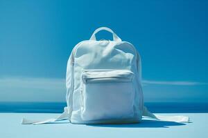 White backpack on a sky background. Back to school concept. Copy space. photo