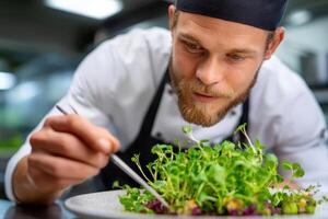 Chef preparing a fresh salad garnished with microgreens in a mod photo