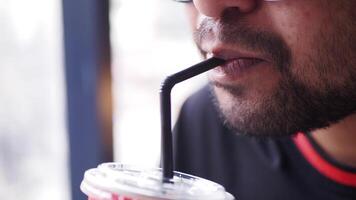 Enjoying a cold drink through a straw at a cafe video