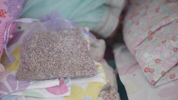 Lavender sachet resting on cozy bedding collection video