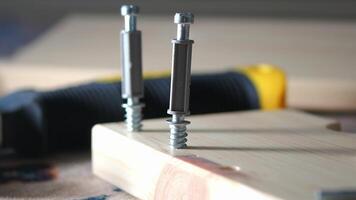 Working with screws and wooden boards in a workshop setting video
