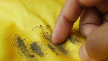 Removing dirt from a yellow fabric using fingertips video