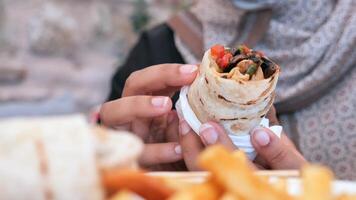 Enjoying fresh wrap with fries at a local street food stall video