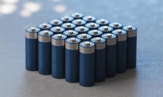 Neat pile of dark blue AA batteries, close up view, symbolizing power and energy solutions photo