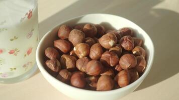 Nut-filled bowl on a sunny table during morning hours video