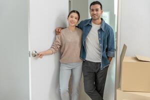 Moving house, relocation, Couple look in space room for furniture in new house, inside the room was a cardboard box contain personal belongings. move in the new apartment or condominium. photo