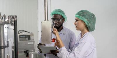 supervisor or food or beverages technician change parameter and condition control food or beverages before send product to the customer. Production leader recheck machine and productivity. photo