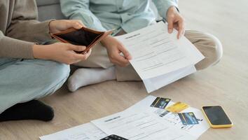 Stressed and headache asian couple with large bills or invoices no money to pay to expenses and business problem. shortage, Financial problems, mortgage, loan, bankruptcy bankrupt photo