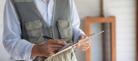 engineer is inspect construction and quality assurance new house using a checklist. Engineers or architects or contactor work to build the house before handing it over to the homeowner. photo