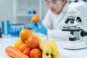 Scientist check chemical food residues in laboratory. Control experts inspect quality of fruits, vegetables. lab, hazards, ROHs, find prohibited substances contaminate photo